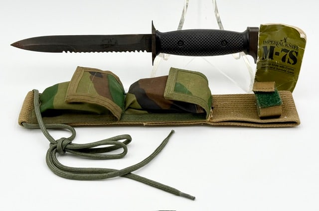 Imperial M-7S Survival Knife: Imperial M-7S Survival Knife. Knife features a 6.75" spear shaped "bayonet ground" blade. Blade is distinctive for its serrated top edge and saw teeth on the spine. Checkered composite grip handle, a 
