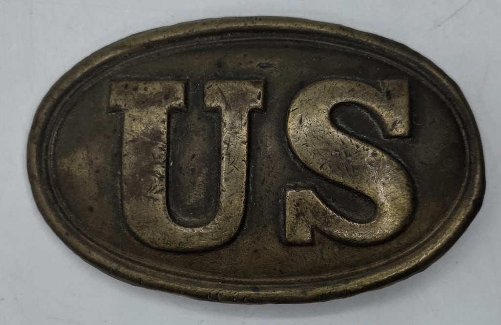 U.S. M1839 Civil War Belt Plate: U.S. M1839 Civil War belt plate. Oval plate made of stamped brass with the letters "US". Back is filled with lead containing arrow hooks. Approximately 2"h x 3.25"w. Photos are considered part of the