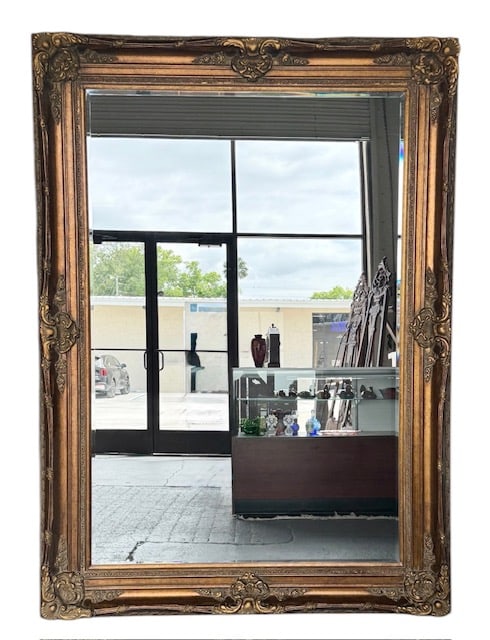 Large 87" Carved Baroque Style Wall Mirror: Large carved baroque style wall mirror. Antique gold finish. Some wear present in frame. Approximately 87"h x 64"w x 3.25"d. Photos are considered part of the condition and description. 120-3