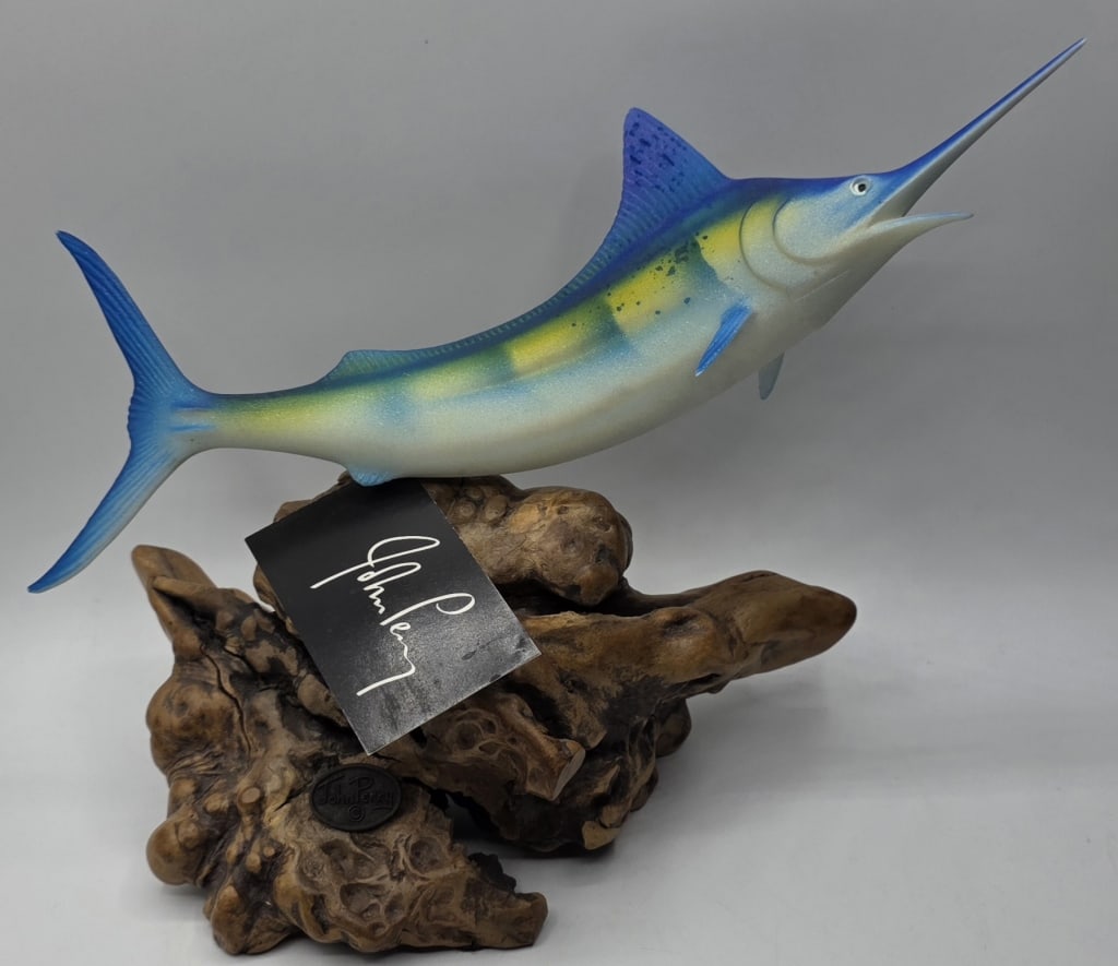 John Perry Handcrafted Blue Marlin Sculpture: John Perry handcrafted blue marlin sculpture. Molded from pellucida and then airbrushed and frosted. Mounted on a polished burlwood base. Approximately 7.5"h. Photos are considered part of the conditi