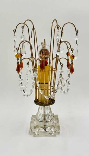Hollywood Regency Style Waterfall Table Lamp: Vintage Hollywood Regency style crystal waterfall table lamp. Lamp features removal cage with curved wire "arms" that cascade outward like a fountain, adorned with dangling crystal prisms. Clear glass