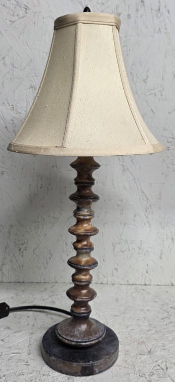 MCM Stacked Spindle Table Lamp: Mid-Century Modern stacked spindle table lamp. Lamp features unique turned and stacked spindle design. Composition unknown. In working condition. Felt lined bottom. Approximately 22"h. Photos are cons