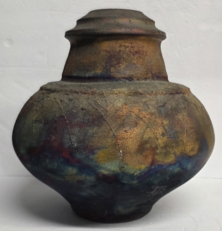 Artist Signed Raku Pottery Vessel: Artist signed handcrafted Raku pottery vessel. Vessel features a bulbous silhouette and a multi-toned, earthy finish with swirling patterns. Signed 1996. Approximately 11.5"h. Photos are considered pa