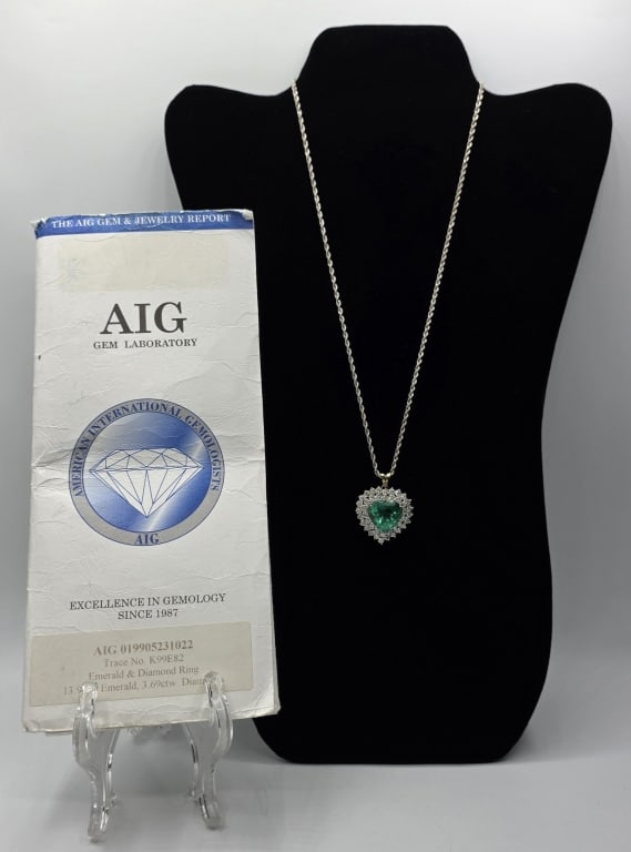 14k 13.9ct Emerald Pendant w. Chain 16.9g CTW: Stunning 14k emerald and diamond pendant on 14k white gold rope chain with AIG appraisal and gemstone grading report. Pendant features 13.97ct heart shaped emerald surrounded by 42 round prong set dia