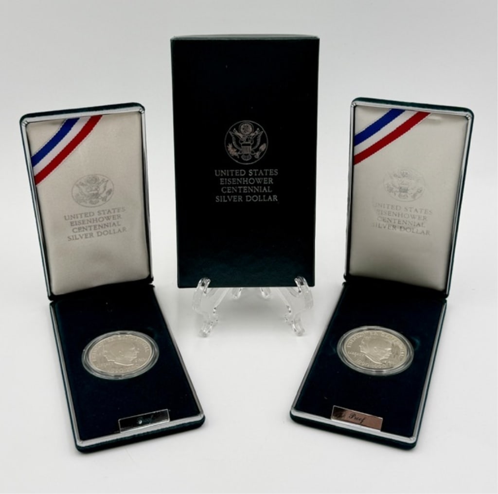 Pair of 1990 Eisenhower Centennial Silver Dollars: Pair of 1990-P Eisenhower Centennial silver dollar proofs in original US Mint presentation cases with boxes and sleeves. Each coin is made of 90% silver weighing 26.73g. Both coins come in protective 