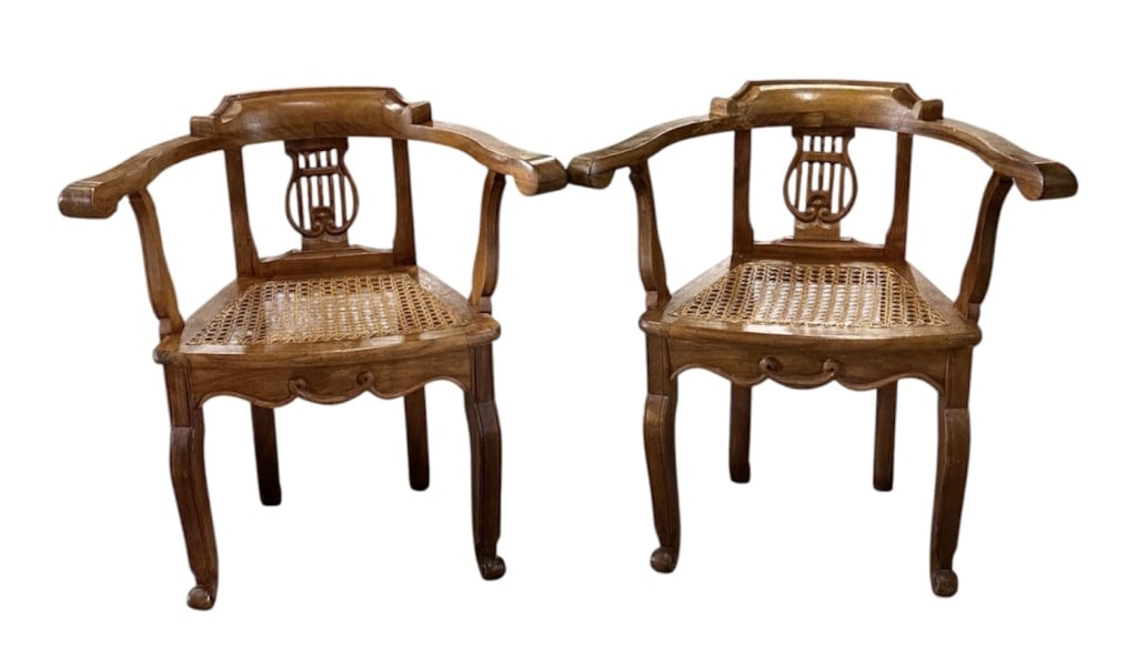 Pair Vintage Lyre Back Cane Seat Arm Chairs: Pair of vintage lyre back cane seat arm chairs. The chairs have a wooden frame featuring a pierced lyre center splat and outward flared arms, supported by decoratively carved stiles. They have ribbon 