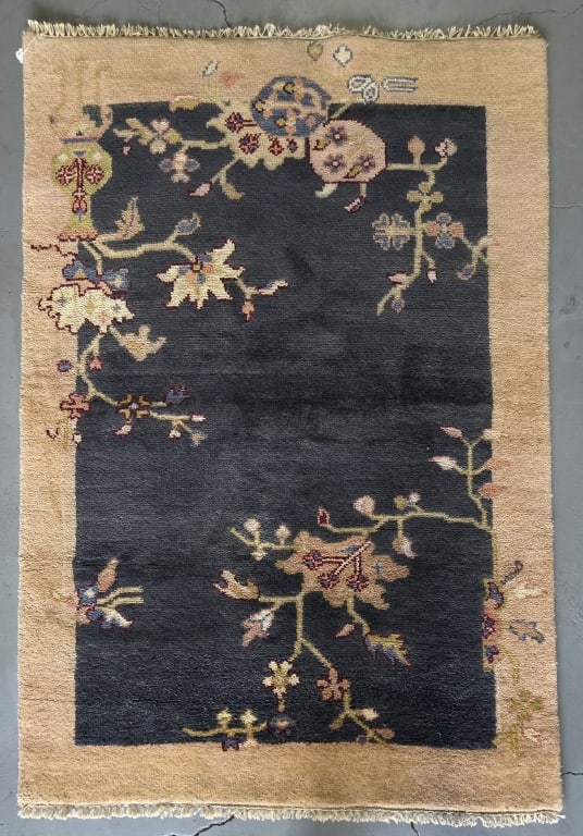 Hand Knotted Chinese Art Deco Wool Rug: Chinese art deco hand knotted wool rug. Featuring a navy blue center field with floral motifs surrounded by a camel colored border. Approximately 75" x 48". Photos are considered part of the condition