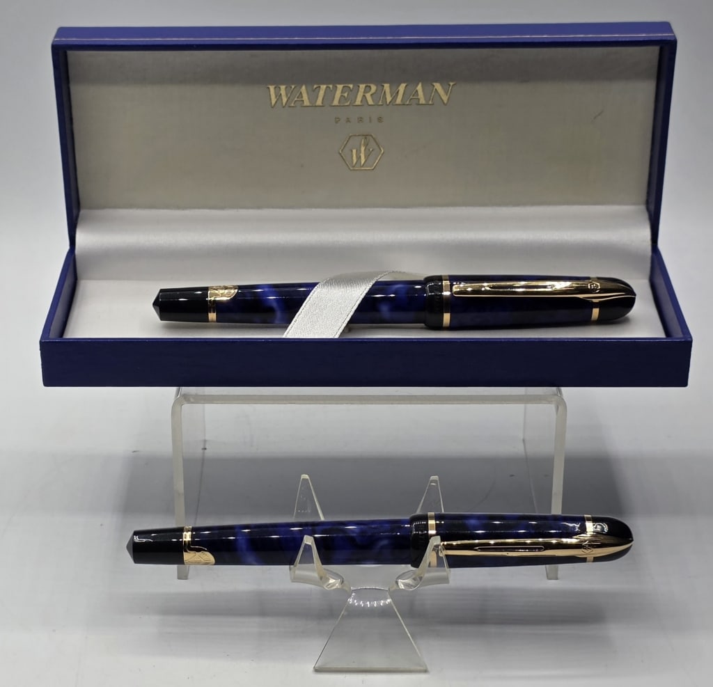 Pr. Waterman Phileas Blue Marble Rollerball Pens: Pair of Waterman Phileas rollerball pens. Blue marble finish with gold plated trim. Presented in an original Waterman Paris branded gift case. Pens approximately 5.25" long and case approximately 7" x