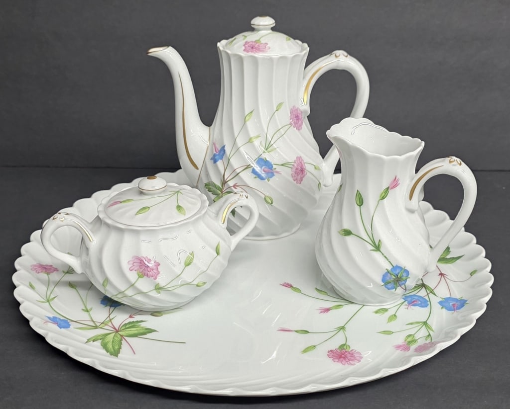 Vintage Haviland Limoges "Florence" Tea Set: Vintage Haviland Limoges "Florence" ceramic tea set. Featuring a delicate pink and blue floral design. The set includes a 6.25"h teapot with lid, 2.5"h covered sugar bowl, 4"h creamer, and a 12" servi