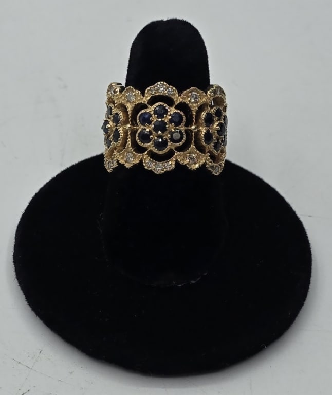 14k Sapphire & Diamond Filigree Ring - 9.3g TW: Vintage sapphire & diamond filigree ring. 9.3g TW. 21 Sapphires arranged in a floral pattern bordered with diamonds at the top and bottom. Marked BH on inside. Size 6.75. Photos are considered part of