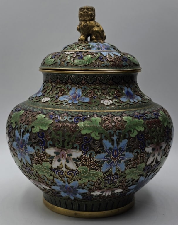Vintage Chinese Cloisonne Ginger Jar: Vintage Chinese cloisonne ginger jar featuring an intricate floral design and a golden foo dog finial on the lid. Approximately 7.5"h. Photos are considered part of the condition and description. 817-