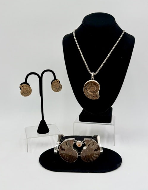 Vintage Sterling Ammonite Fossil Jewelry Set: Vintage sterling ammonite fossil jewelry set. Set includes necklace, pair of clip on earrings, and bracelet all set in 925 sterling silver. Necklace features 2.5" x 1.5" pendant on 24" chain, chain ap