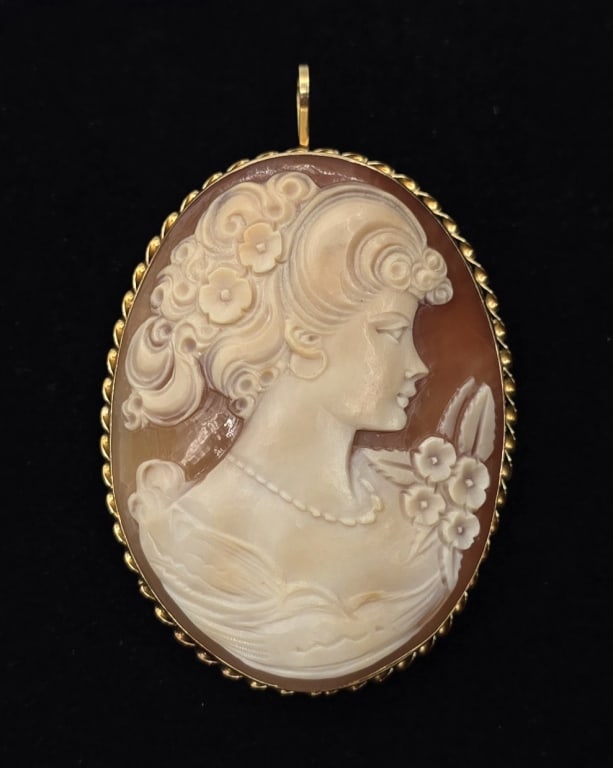 14k Cameo Brooch: 14k Cameo brooch/pendant. Beautiful shell cameo in 14k yellow gold brooch setting with hinged pendant bail. Twisted trim around outside edge. Approx. 1.5"W x 2"H (2.5" including bail). Photos are cons