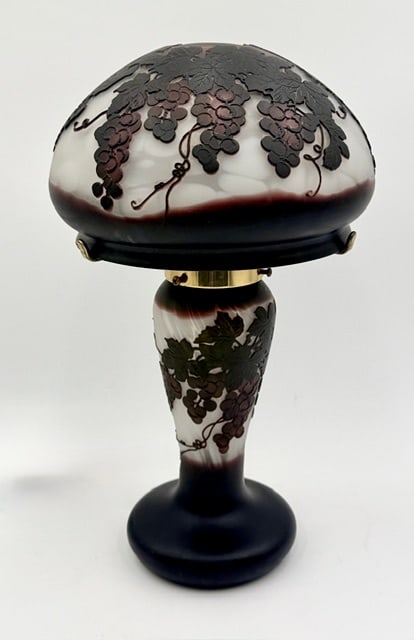 Lovely Galle Style Cameo Glass Table Lamp: Lovely Galle style cameo glass table lamp. It features a dome shaped shade and matching base, crafted from multilayered glass to create a raised, dimensional relief of grapevines and fruit cluster. Si