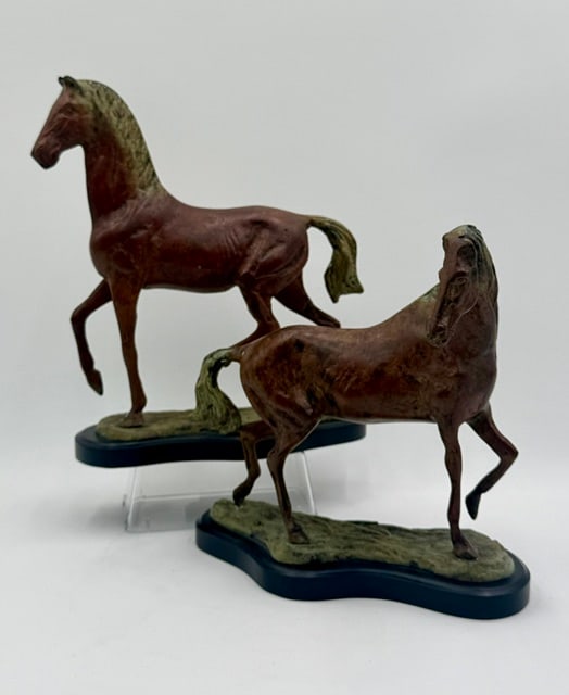 Pair of Painted Bronze Horse Sculptures: Pair of painted bronze horse sculptures. Includes a stallion and a mare captured in dynamic, realistic movement with detailed musculature. Approximately 11.25"h x 9.5"l x 3.5"d and 9.25"h x 10"l x 4"d