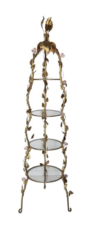 Vintage Italian Florentine Tole Etagere: Vintage Italian Florentine tole etagere. Features a gold gilt finish, intricate vine details, and delicate porcelain flowers. 4 Round glass shelves. Single top light. Hardwired, cord not included. App