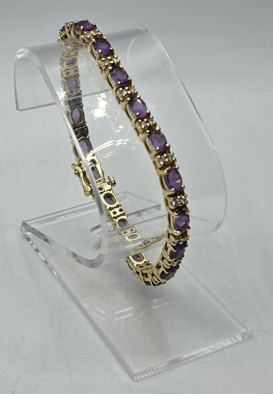 14k Diamond Amethyst Tennis Bracelet - 20.8g TW: 14k Amethyst(?) diamond tennis bracelet. 20.8g TW. Approx. 7"L. Bracelet consists of 19 oval cut prong set purple stones (believed to be amethyst) alternating between 2 round prong set diamonds (38 to