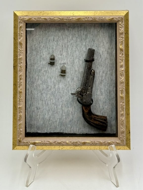 Vintage Pocket Pinfire Pistol & Bullets Shadowbox: Vintage pocket pinfire pistol and bullets shadowbox. Mounted against a textured gray fabric backdrop inside a decorative gold and cream colored wooden frame with back hanging hooks. Items have not bee
