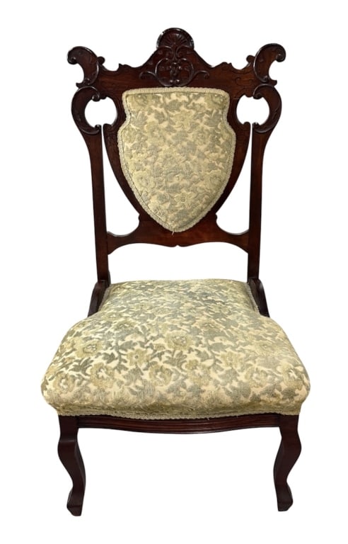 Antique Victorian Carved Parlor Chair: Antique Victorian carved parlor chair. Constructed with an intricately carved solid wood frame featuring elaborate scrolls, pierced wood accents, and a distinct shield shaped padded back splat. The se
