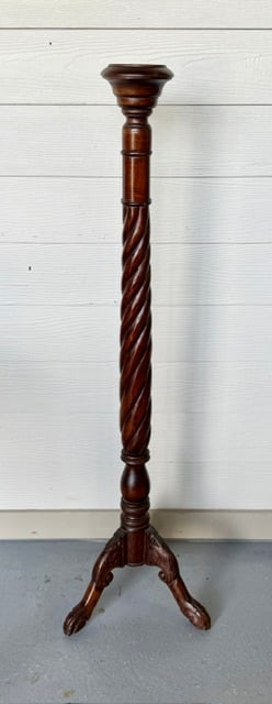 Handcrafted Mahogany Torchere Stand: Handcrafted mahogany torchere stand. Stand features hand carved spiral column supported by tripod base. 3.75" Candle holder recessed top area. Made in Indonesia. In good condition with some tape resid