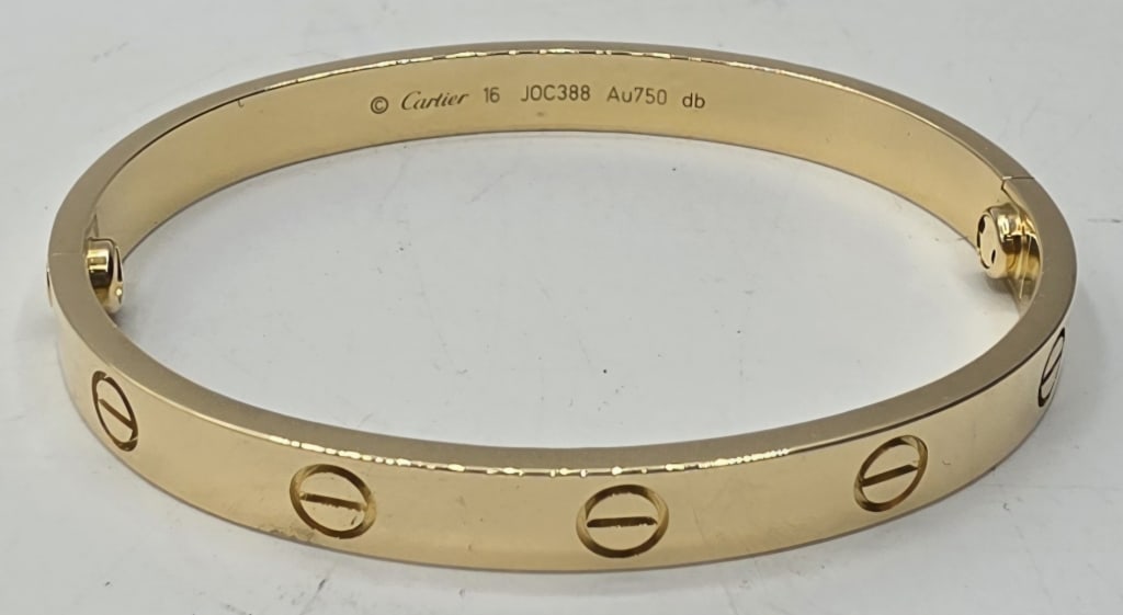 Beautiful 18k Classic Cartier Love Bracelet: Beautiful 18k yellow gold classic Cartier Love bracelet. Size 16. Serial number JOC388. Bracelet has been authenticated and is in excellent condition. Includes original box and paperwork. Photos are c