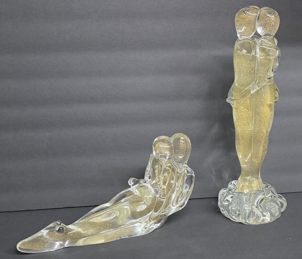 MCM Murano Art Glass "Lovers" Sculptures: Pair of Murano Art Glass MCM "Lovers" sculptures. Sculptures infused with 24K gold leaf flakes and signed by artist Sandro Frattin. Includes 5"h x 10" reclining couple and 12"h standing couple. Made i