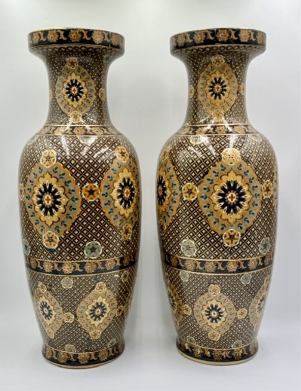 Pair of Vintage Hand Painted Chinese Vases: Pair of vintage Chinese vases. Vases feature a distinctive blue, gold, and cream abstract floral motif with raised, textured hand painted enamel details heavily accented with gold gilt lining.