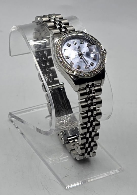 Beautiful Ladies Rolex 26mm Datejust Wristwatch: Beautiful ladies Rolex 26mm custom Datejust wristwatch. 2003 Watch features stainless steel case, custom glacier blue diamond dial, and custom diamond bezel. Jubilee bracelet. Model number 79240, Seri