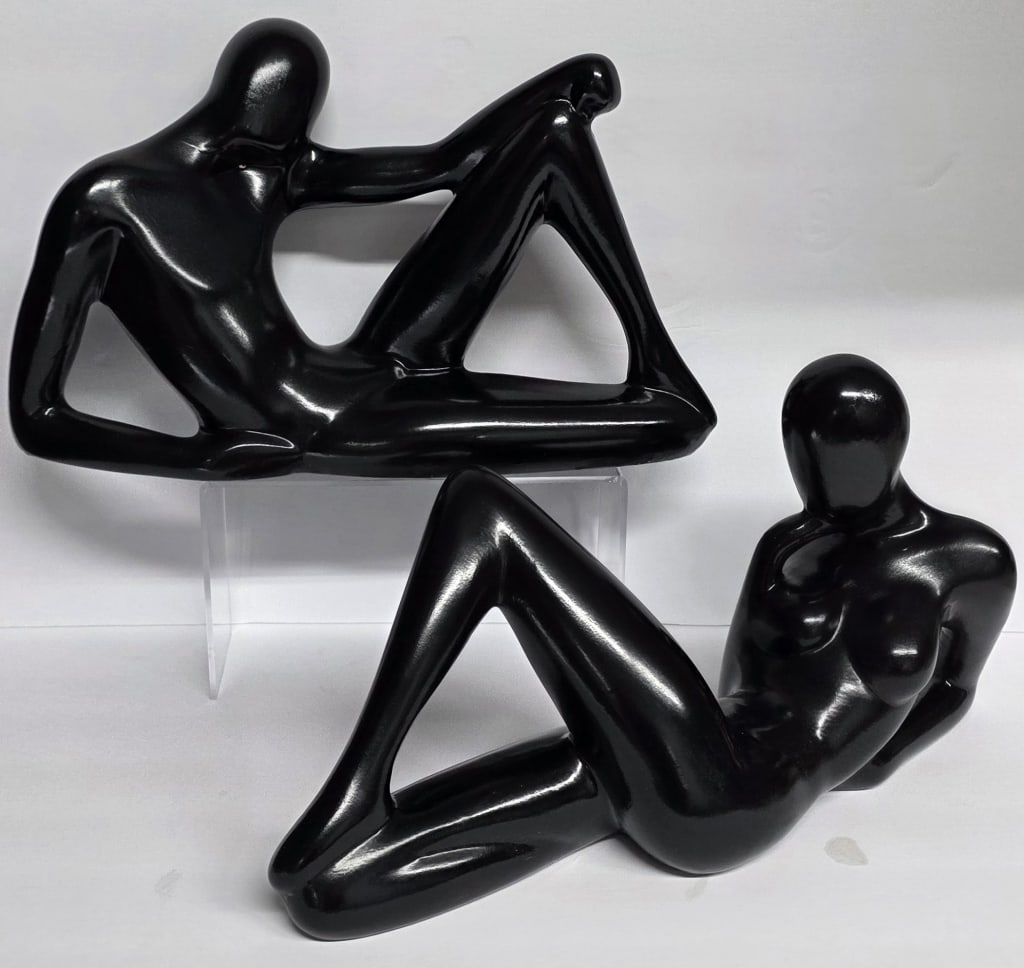 Pr. Vintage Abstract Cubist Modern Sculptures: Pair of vintage abstract ceramic sculptures. Modern sculptures depict a reclining cubist man and woman in a glossy black finish. Approximately 9"h x 16"l. Photos are considered part of the condition a
