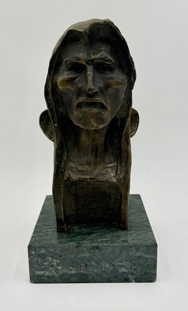 "The Savage" Bronze Bust after F. Remington: "The Savage" bronze bust in the style of Frederic Remington. Sculpture features a patinated finish and mounted on a green marble base. Two small chips present in marble base. Approximately 11.75"h x 6