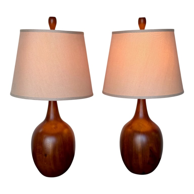 Pair Vintage Danish Modern Teak Table Lamps: Pair of vintage Danish modern teak table lamps. Lamps feature a solid teak wood base and a tapered fabric shade. Imperfection/knot present on one lamp. In working condition. Approximately 31"h x 15.5"