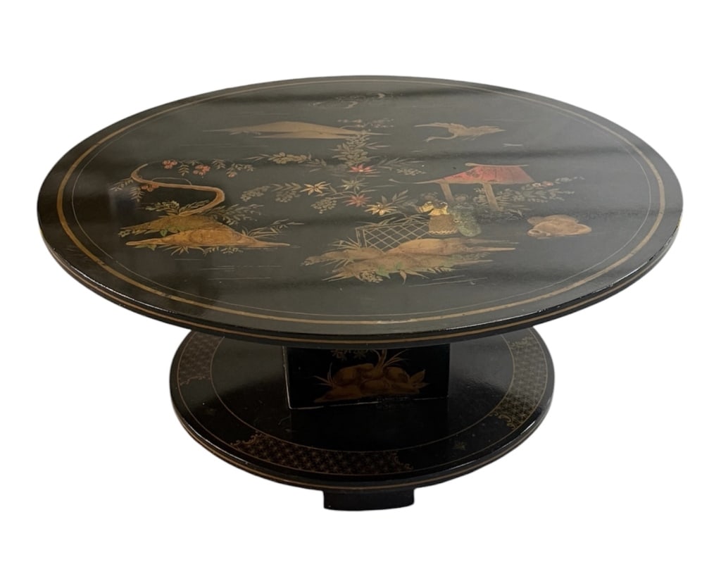 Vintage Chinese Black Lacquer Round Coffee Table: Vintage Chinese black lacquer round coffee table. The top surface is adorned with gold accented hand painted traditional landscape vignettes, regional architecture, figures, and flying birds and is su