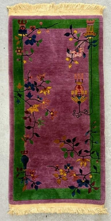 Hand Knotted Chinese Art Deco Rug: Hand knotted Chinese Art Deco rug. Features a vibrant magenta purple central field framed by a rich green border and finished with a cream toned fringe. Approximately 51" x 23.5". Photos are considere