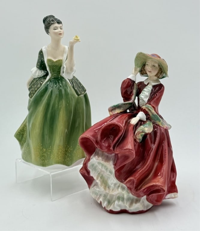 Pair of Collectible Royal Doulton Lady Figurines: Pair of collectible Royal Doulton lady figures. Figurines made from hand painted fine bone china. Set includes 7.75" "Fleur" and 7" "Top o' The Hill. Both in excellent condition with no chips or crack