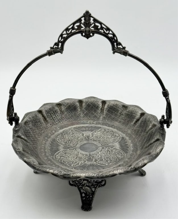 James W. Tufts Silver Plated Bride's Basket: Antique James W. Tufts quadruple silver plated bride's basket. Produced in Boston during the late 19th century. Features ornate swing handle, intricate chiseled floral engravings on the bowl, and deta