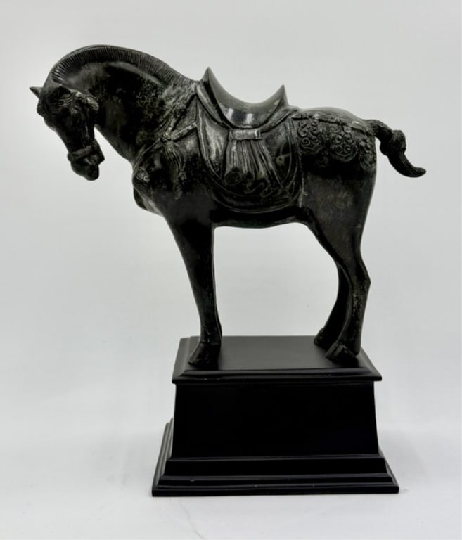 Vintage Metal Tang Dynasty Style Horse Sculpture: Vintage cast metal Tang Dynasty horse sculpture. Mounted atop a geometric, tiered black pedestal base. Approximately 12.25"h x 11"w x 5.5"d. Photos are considered part of the condition and description
