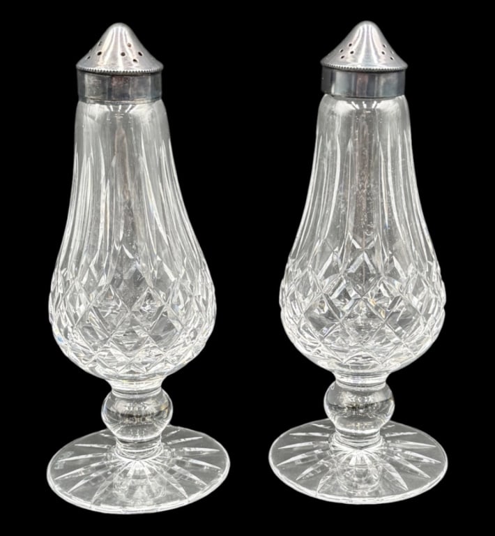 Set of Vintage Waterford Crystal Shakers: Set of vintage Waterford Crystal shakers. Shakers feature the iconic 'Lismore' pattern and EPNS metal lids. Small chip present on one base. Approximately 6.25"h. Photos are considered part of the cond