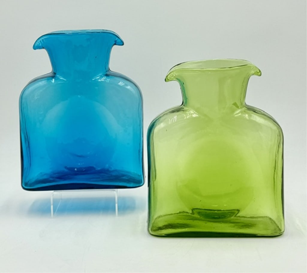 Vtg. Blenko Style No. 384 Water Bottles: Pair of vintage Blenko style No. 384 water bottles. Bottles feature a flat, canteen style body with two pouring spouts and a distinctive center circular indentation meant for easy handling. Both in