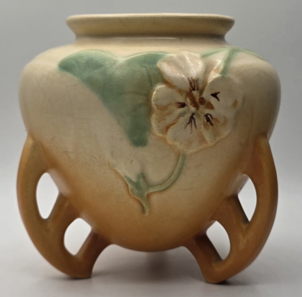 Antique Weller Pottery Panella Urn Vase: Antique Weller Pottery Panella 3 footed urn vase. Vase features a shaded orange and green glaze with yellow pansies and art deco handles. In excellent condition with no chips or cracks. Approximately