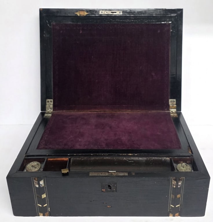 Antique Victorian Writing Box: Antique Victorian writing slope. Box opens to reveal a sloped velvet writing surface, a pen tray, and dedicated storage slots for included inkwells. Features a black veneer exterior with moth of pearl