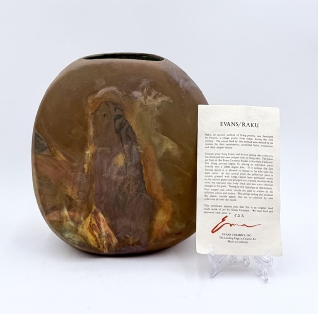 Tony Evans Handcrafted Raku Pottery Vessel: Tony Evans handcrafted Raku pottery vessel. Created using the traditional Raku firing techniques. Vessel features a brown and orange crackle finish. Some natural crazing present. Signed and numbered o