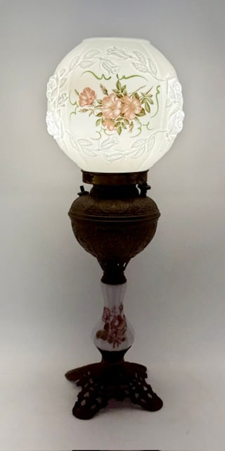 Vintage Electrified Gone with the Wind Style Lamp: Vintage electrified Gone with the Wind style table lamp. Lamp features a white milk glass globe with a hand painted pink floral design, embossed details, and metal base. In working condition. Approxim