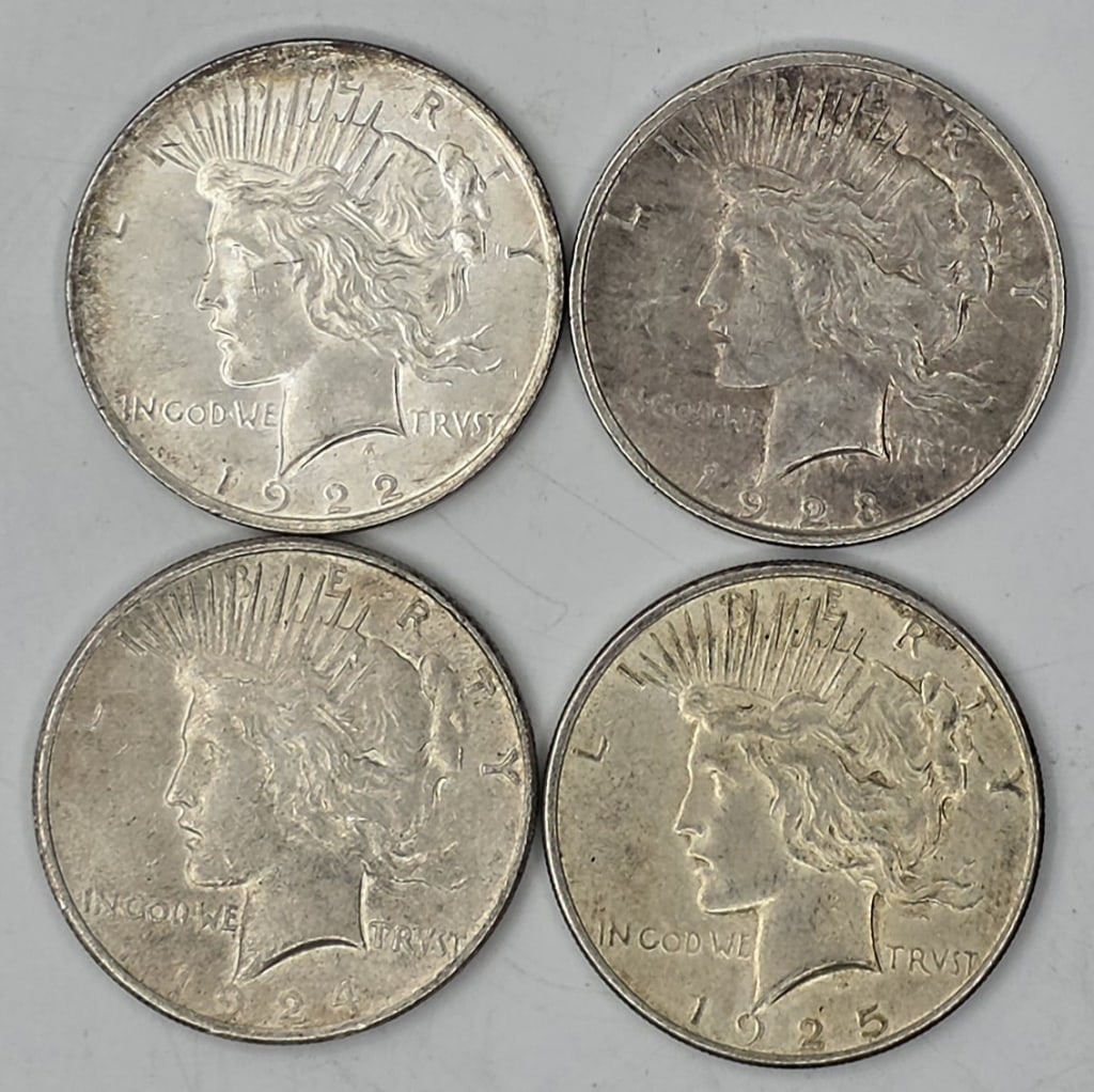 Set of Four United States Peace Silver Dollars: Set of four United States Peace Silver Dollars. Minted from 1922 to 1925. Each coin is composed of 90% fine silver and 10% copper. Photos are considered part of the condition and description. R#2