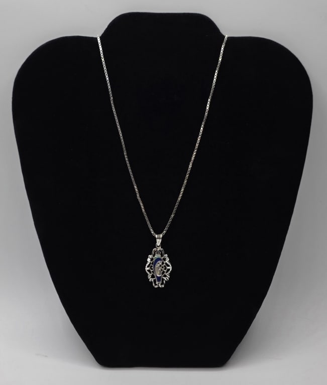 18k Virgin Mary Pendant and Box Chain - 10.53g TW: 18k Virgin Mary pendant and box chain. 18k White gold pendant with enamel image of the Virgin Mary - 2.94g TW. Pendant is hung on 20" white gold heavy box chain - 7.59g. 10.53g Combined total weight. 