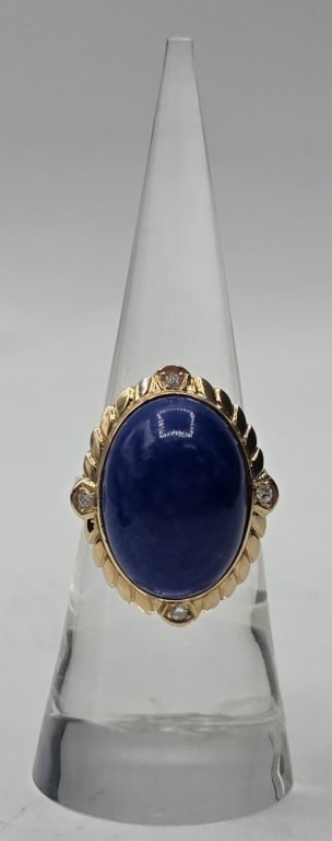 14k Lapis and Diamond Ring - 6.34g TW: 14k Lapis and diamond ring. Large center oval lapis cabochon set in yellow gold and surrounded by rope detailing with 4 accent diamonds. 6.34g TW. Size 6.5. Approx. 1"H x 0.75"W. Photos are considered