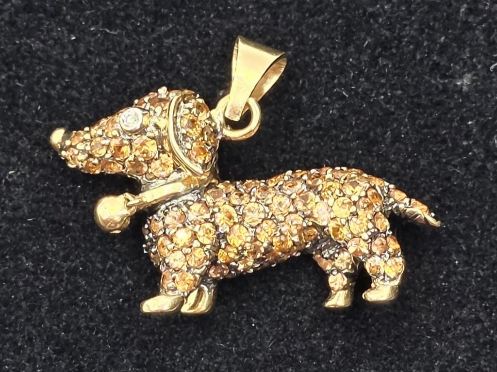 14k Gemstone Dachshund Pendant - 3.8g TW: 14k Gemstone dachshund pendant. 3.80g TW. Champagne colored gemstones set in 14k yellow gold with diamond eye and polished yellow gold feet, nose, and collar with charm. Approx. 0.75"h x 1"w. Photos