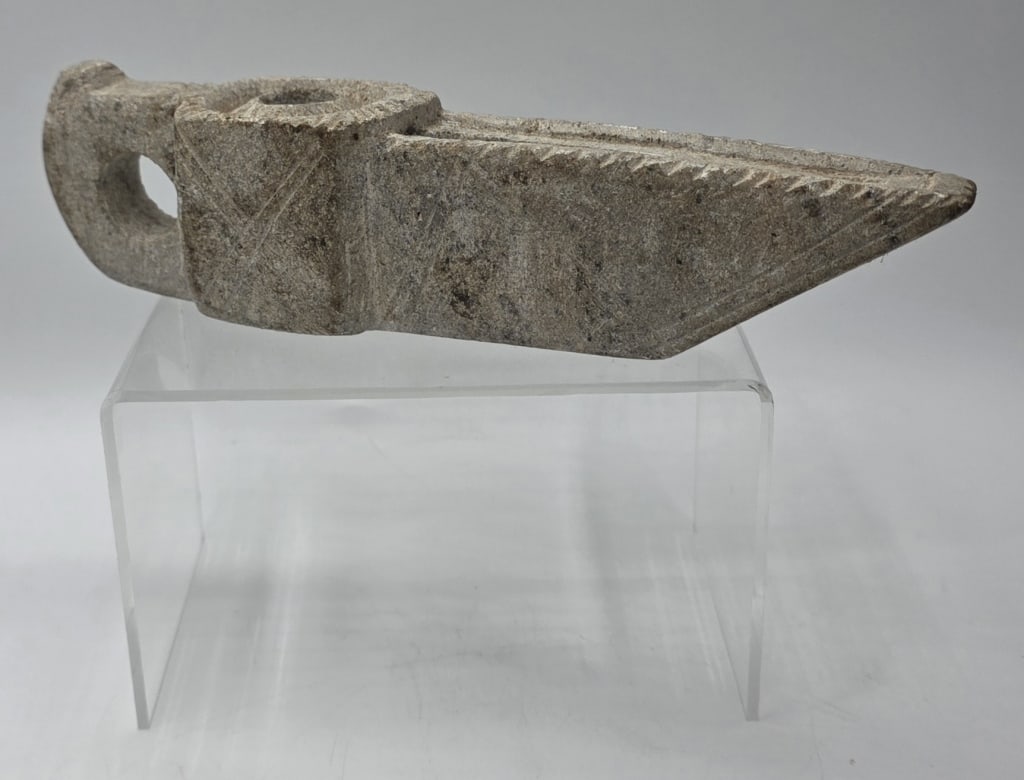 Byzantine Era Style Carved Stone Oil Lamp: Byzantine era style hand carved stone oil lamp. Carved from a single piece of stone, featuring a tapered body that narrows toward the wick nozzle, a central round reservoir hole, and an integrated fin