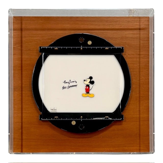 "Disney's Mickey Mouse Works" Cel & Animation Disc: "Disney's Mickey's Mouse Works" Cel, signed by producers Bobs Gannaway and Tony Craig. The rare animation cel has been mounted to a reproduction animation disc. Housed in a wood and plexiglass display