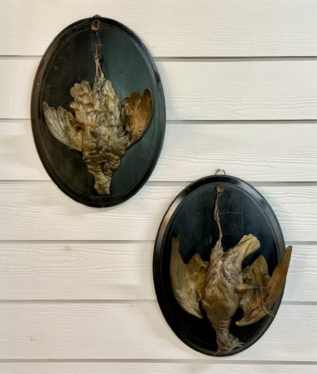 Antique French Hanging Game Bird Wall Plaques: Pair of antique French hanging game bird wall plaques. Dimensional metal castings with a brass patina depicting suspended hunting trophies. Mounted on wood panels equipped with hanging loops. In good 