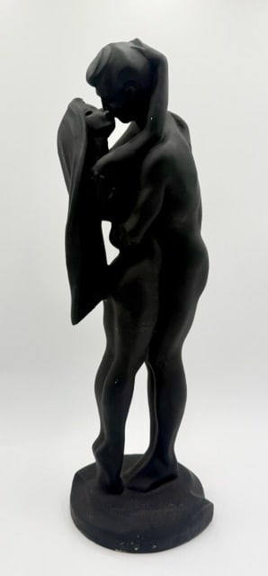 Austin Productions "Tender Kiss" Sculpture: Austin Productions "Tender Kiss" sculpture. Durastone sculpture depicts a nude couple in a passionate embrace. Matte black finish. Some scratches and imperfections present. Approximately 22.5"h.